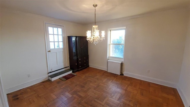 unfurnished dining area featuring dark parquet flooring, a wealth of natural light, and an inviting chandelier