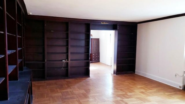 unfurnished room featuring parquet flooring and crown molding