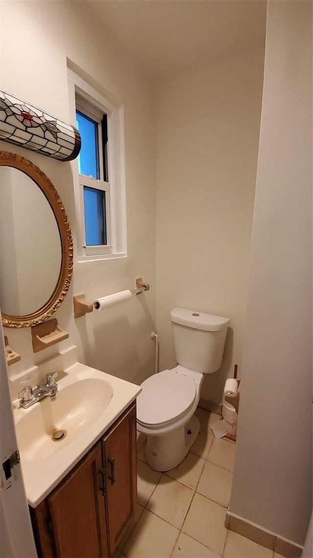 bathroom featuring tile patterned flooring, vanity, and toilet