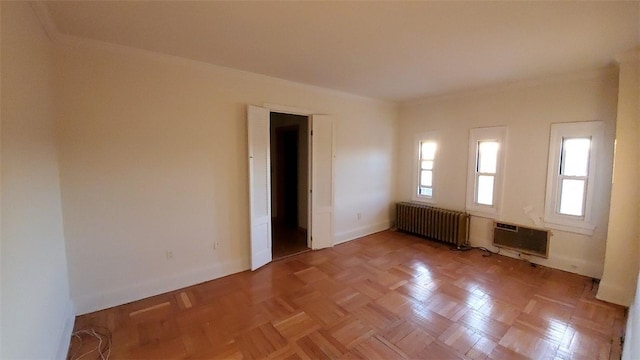 empty room featuring radiator and light parquet flooring