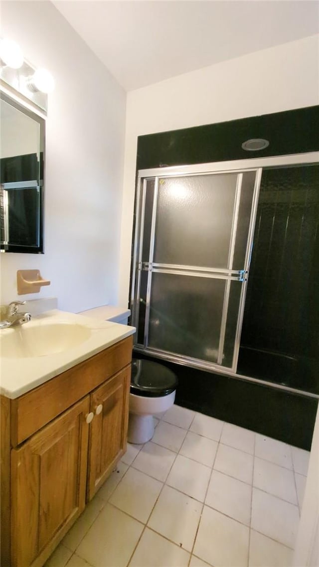 bathroom with tile patterned flooring, vanity, and toilet