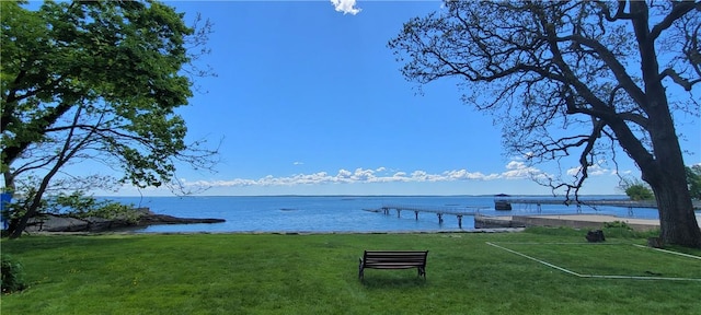 view of dock featuring a water view and a lawn