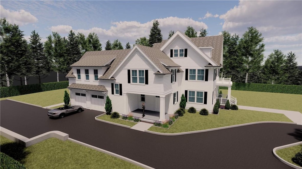 view of front of property featuring a balcony, an outbuilding, a front yard, and a garage