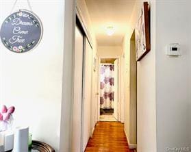 corridor with wood-type flooring