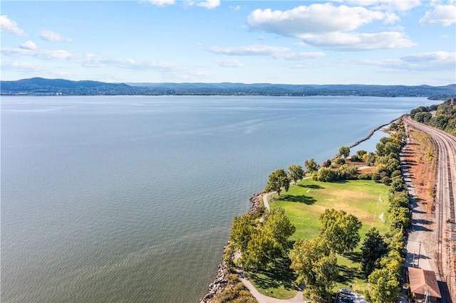 drone / aerial view featuring a water and mountain view