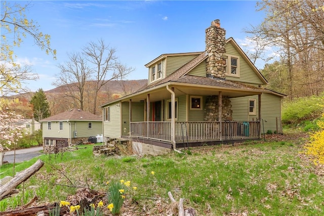 view of front of home with a mountain view and covered porch