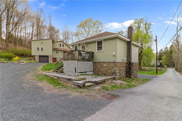 view of front of property featuring a deck and a garage