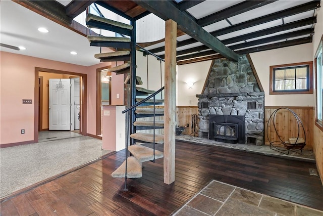 basement featuring a wood stove and dark wood-type flooring