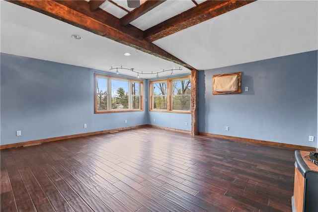 empty room featuring wood-type flooring and beam ceiling