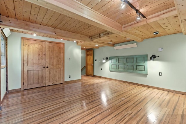 interior space featuring beamed ceiling, track lighting, wood-type flooring, and wooden ceiling