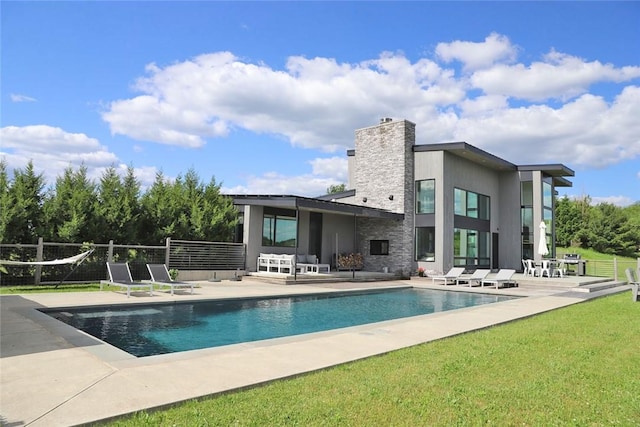 view of pool with a yard and a patio