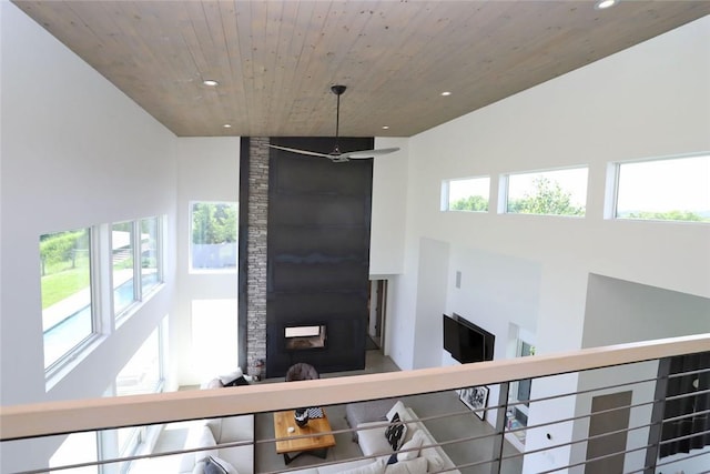 interior space featuring a stone fireplace and wooden ceiling