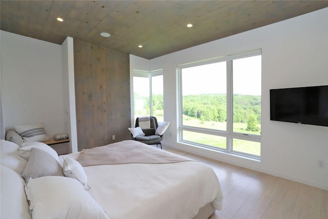 bedroom featuring light wood-type flooring and wooden ceiling