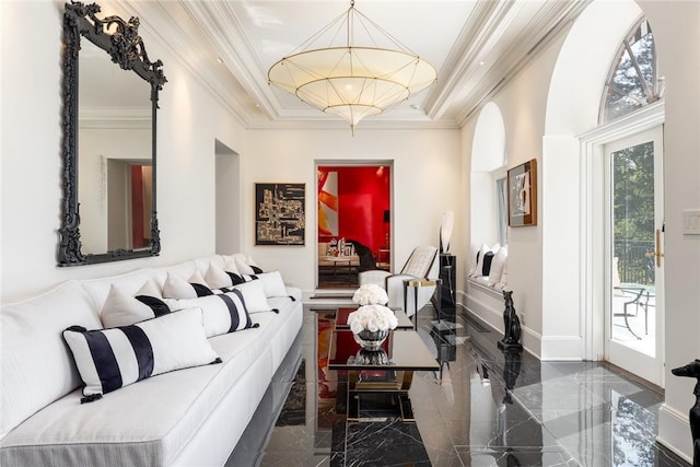 living room with a raised ceiling and crown molding