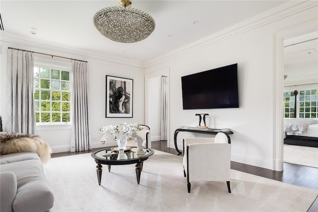 living room featuring a wealth of natural light, wood-type flooring, and ornamental molding