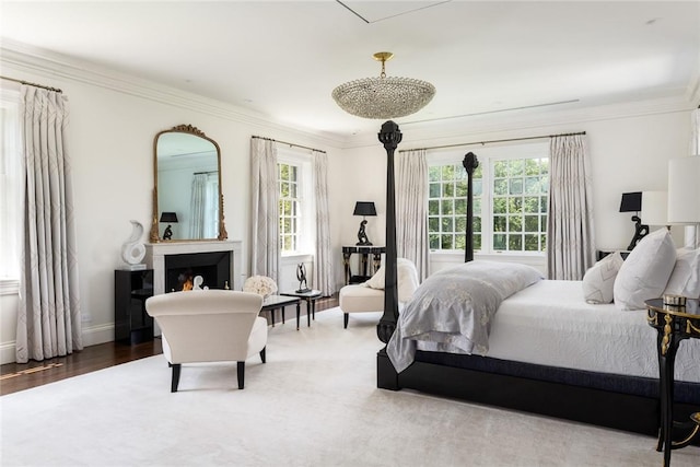 bedroom featuring multiple windows, crown molding, and hardwood / wood-style floors