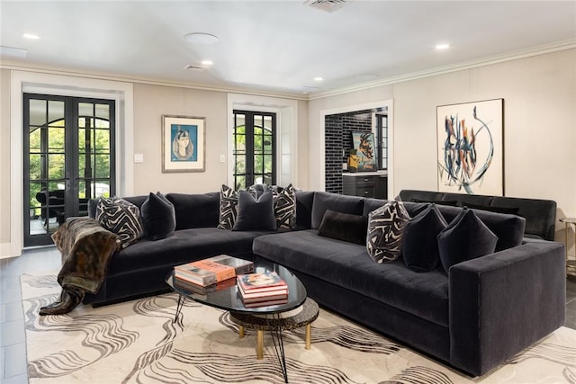 living room featuring a wealth of natural light, french doors, and crown molding