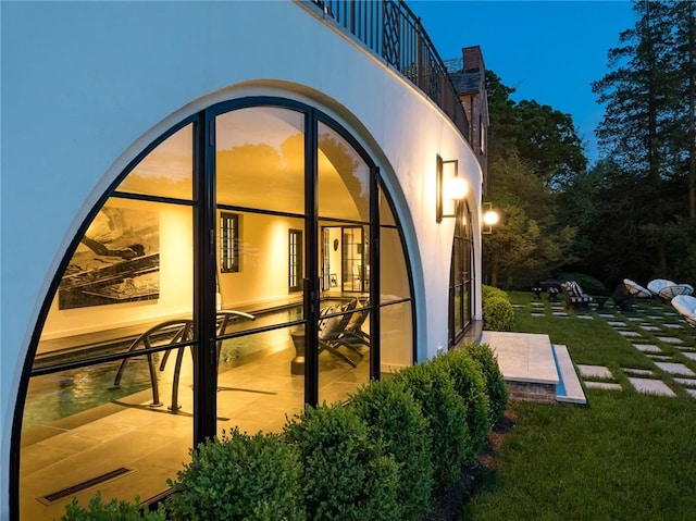 exterior space featuring a yard, a patio, and a balcony