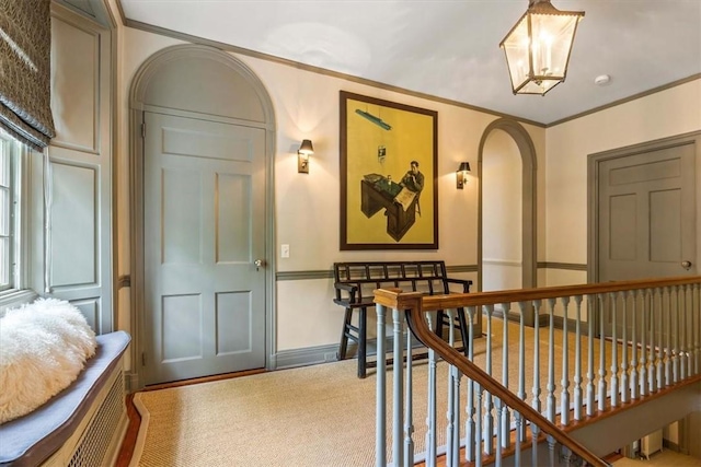 corridor featuring crown molding and carpet floors