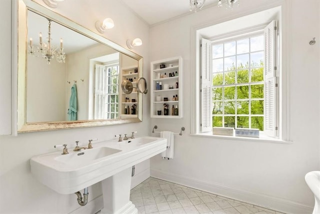 bathroom featuring plenty of natural light, dual sinks, and tile patterned flooring