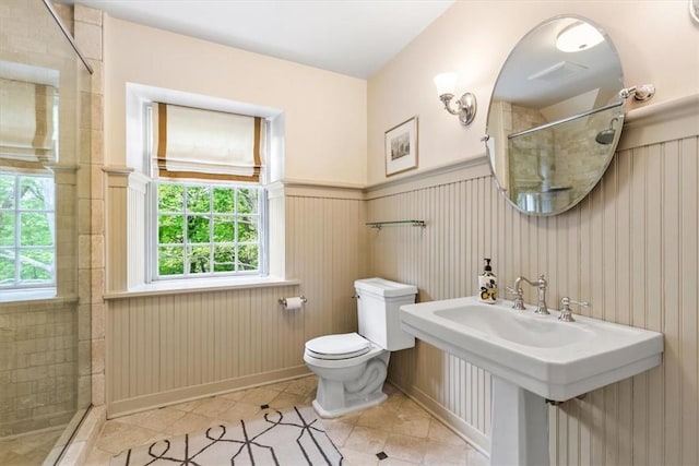 bathroom featuring tile patterned flooring, plenty of natural light, and tiled shower