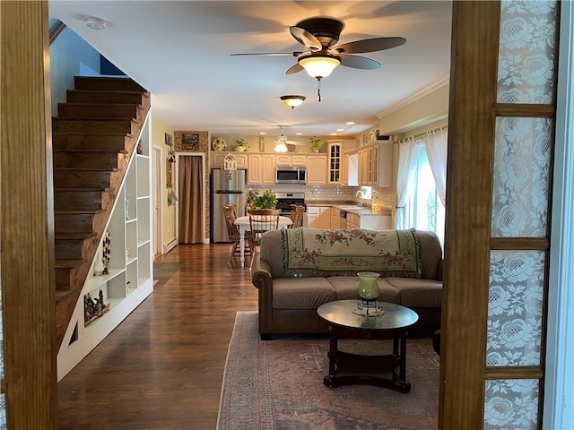 living room with dark hardwood / wood-style floors, ceiling fan, crown molding, and sink