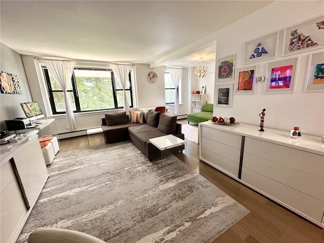 living room with hardwood / wood-style floors, a chandelier, and a baseboard heating unit