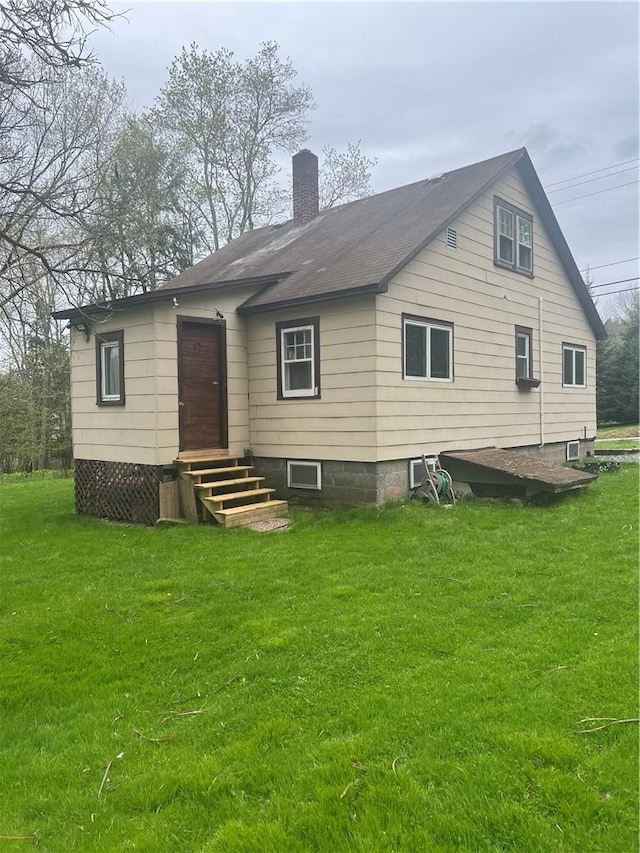 rear view of house with a lawn