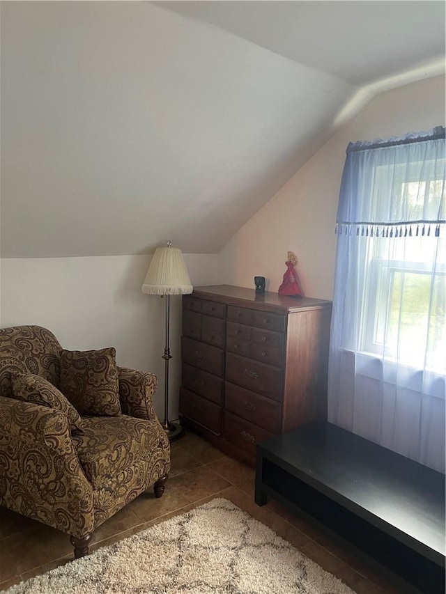 sitting room with tile patterned flooring and vaulted ceiling