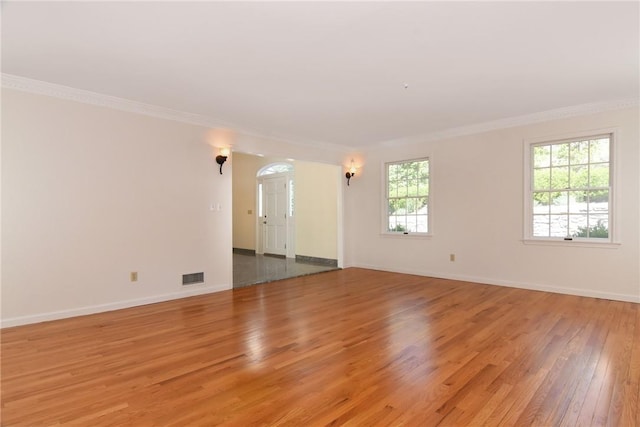 spare room with hardwood / wood-style flooring and ornamental molding