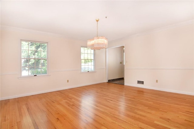 unfurnished room with light hardwood / wood-style floors, plenty of natural light, and crown molding