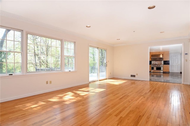 unfurnished living room with light wood-type flooring and crown molding