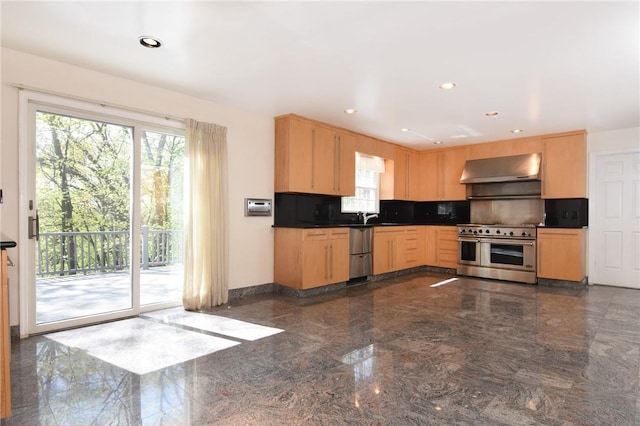 kitchen with sink, range hood, backsplash, light brown cabinetry, and appliances with stainless steel finishes