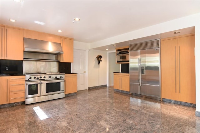 kitchen with premium appliances, decorative backsplash, light brown cabinetry, and exhaust hood