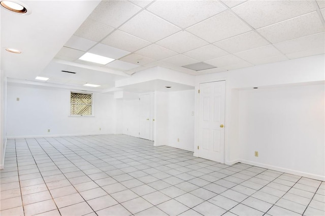 tiled spare room featuring a paneled ceiling