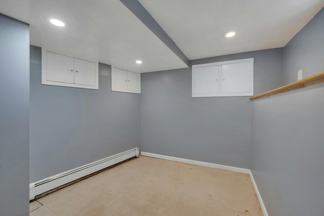 basement featuring a baseboard heating unit