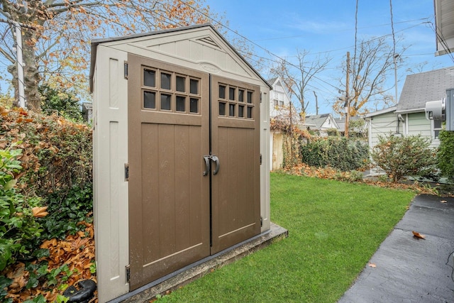 view of outbuilding with a yard