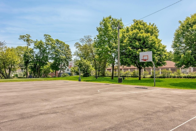 view of sport court with a lawn