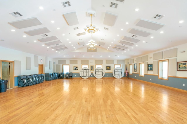 workout area featuring high vaulted ceiling and light hardwood / wood-style floors