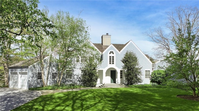 28 Heron Lake Rd, Bedford, NY 10506 - view of front of home with a garage and a front lawn