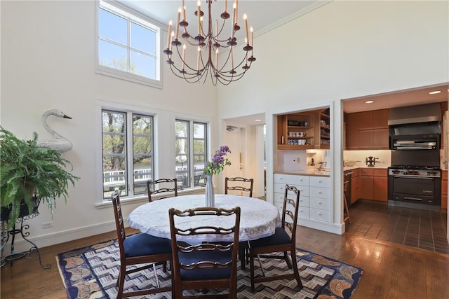 28 Heron Lake Rd, Bedford, NY 10506 - dining area with a towering ceiling, dark wood-type flooring, and an inviting chandelier