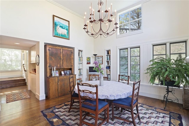 28 Heron Lake Rd, Bedford, NY 10506 - dining room with crown molding, a towering ceiling, a healthy amount of sunlight, and hardwood / wood-style flooring
