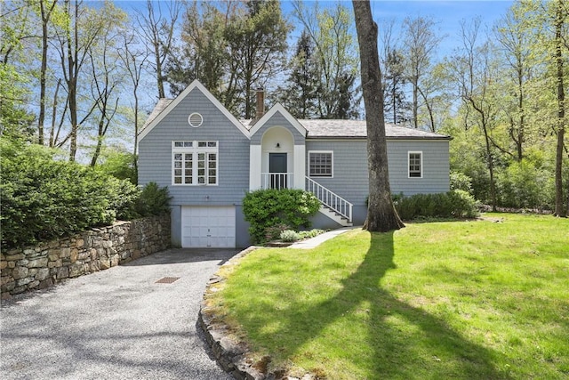 28 Heron Lake Rd, Bedford, NY 10506 - view of front of house with a front lawn and a garage