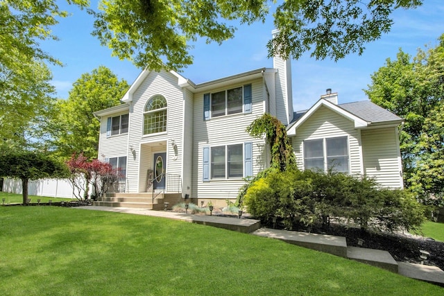 view of front of house with a chimney and a front lawn