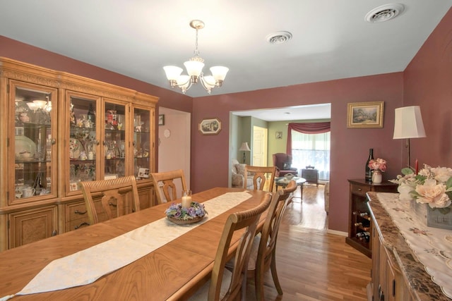 dining area featuring a chandelier and wood finished floors