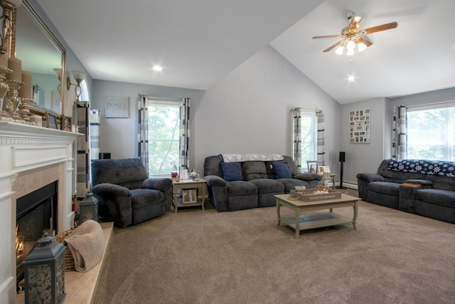 carpeted living room with healthy amount of natural light, a ceiling fan, a fireplace, lofted ceiling, and recessed lighting