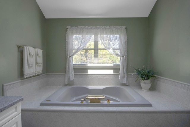full bathroom with a garden tub and vanity