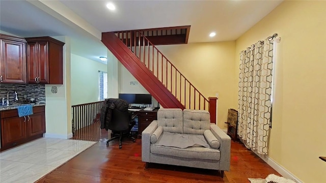 living room with dark hardwood / wood-style flooring and sink