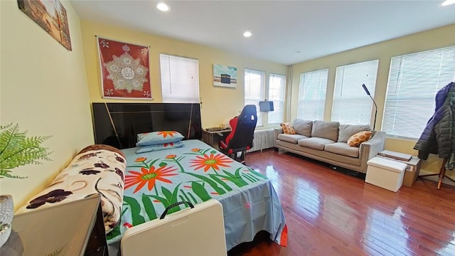 bedroom featuring hardwood / wood-style floors and radiator heating unit