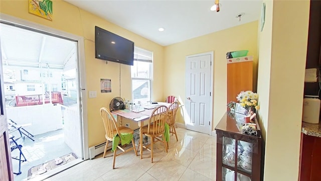 dining space featuring a baseboard heating unit